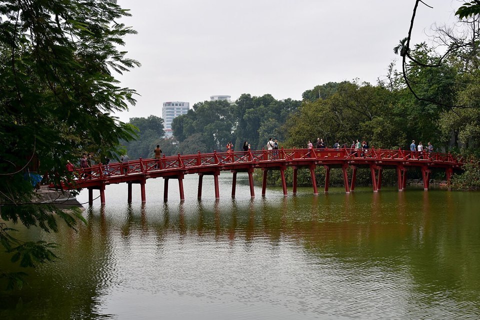 The red Huc Bridge across Hoan Kiem Lake in Hanoi