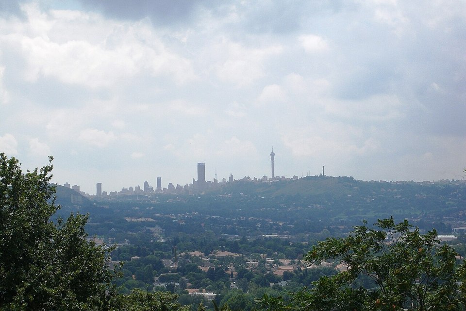 Johannesburg skyline seen across wooded residential hills